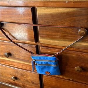 Dooney and Bourke nylon North/South Triple Zip in French blue. Gorgeous Hardware